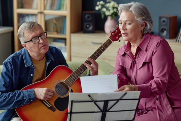 istock Mature Couple Singing Playing Music Creative 2164427147