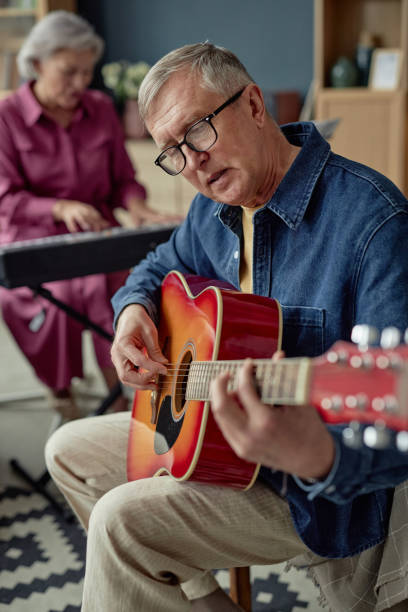 istock Mature Man Playing Guitar Singing Song 2164427153