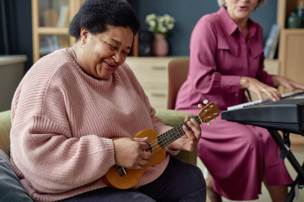 istock Black Mature Woman Playing Ukulele 2164427154