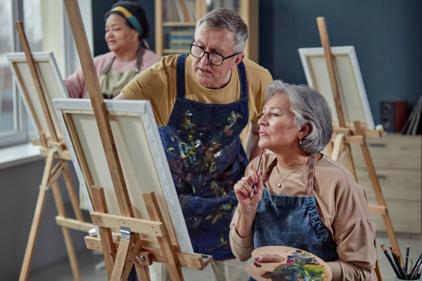 istock Two Mature People Painting in Art Studio 2164427182