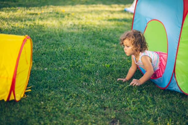Little girl playing in backyard playground
