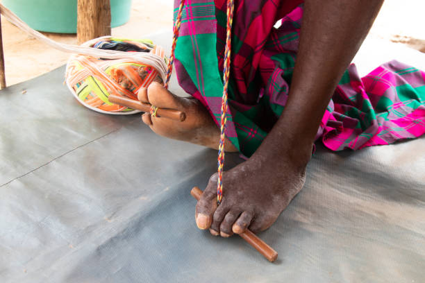 Man weaving a typical Guinea-Bissau cloth, called comb cloth, on the loom, Bissau, 2024