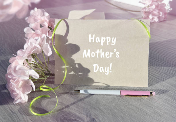 istock A Mothers Day Card Next to Some Flowers 2164436373