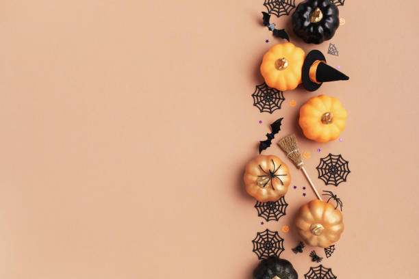 istock Halloween party decorations frame from pumpkins, bats, spider web top view. Happy halloween holiday greeting card flat lay. 2164440910