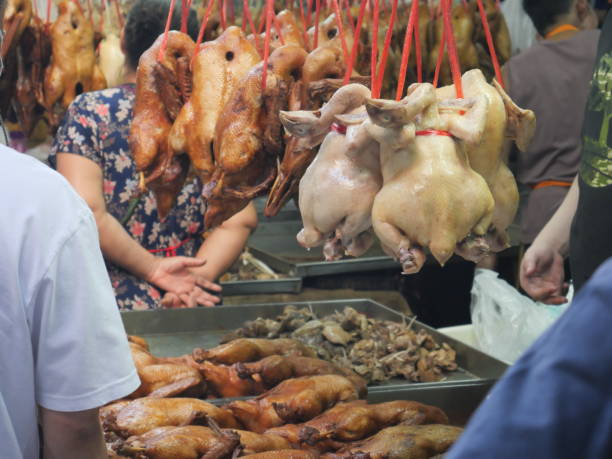 Bangkok, Thailand-February 8, 2024: Food stall selling duck and chicken at the Old Market of Bangkok's Chinatown during Lunar New Year. People shop for food for Lunar New Year in Thailand. The food preparation is used for offering to ancestors, bringing fortune, good luck, and prosperity, as well as for culinary use during family gatherings.