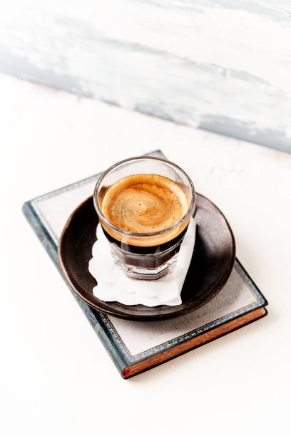 istock Coffee in glass cup on bright wooden background. Copy space. 2164442643