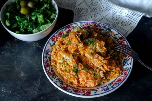istock Shrimp pilaf and lettuce salad on a wooden table 2164456247