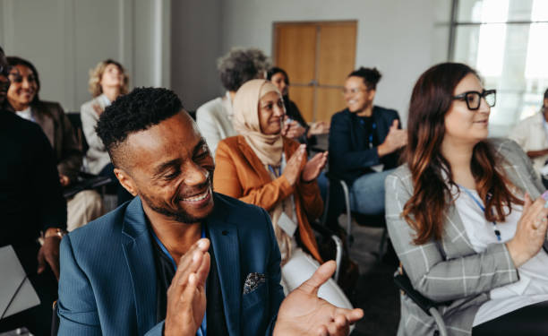istock Multiethnic coworkers applauding and smiling at a workshop 2164465660