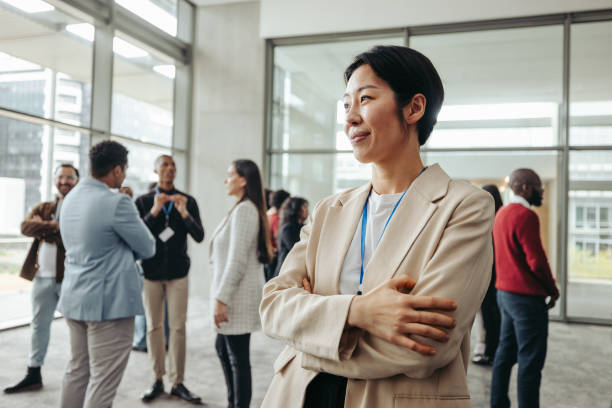 istock Quiet confidence: Professional woman in office networking with colleagues 2164468666