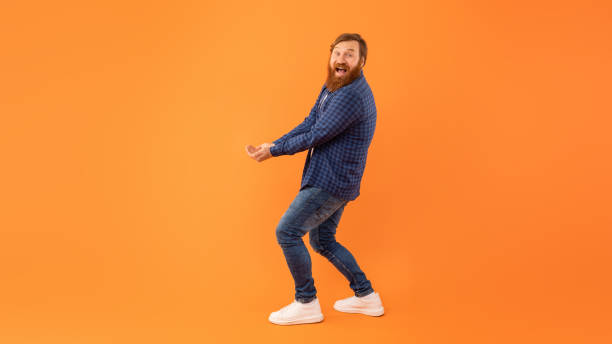 istock Man With Beard Holding Hands Together With Palms Up, Studio 2164475880