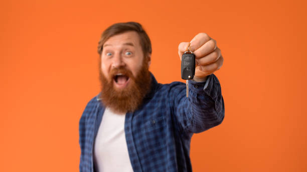 istock Excited Redhaired Bearded Man Shows Car Key In Excitement, Studio 2164475994