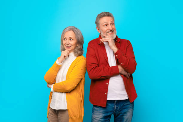istock Thoughtful senior husband and wife standing back to back, studio 2164478065