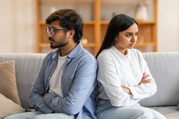 istock Young Couple Having Argument While Sitting On Couch At Home 2164487146
