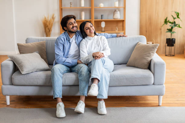 istock Man and Woman Sitting on a Couch, Copy Space 2164487298