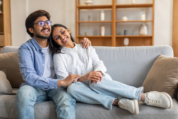 istock A Man and a Woman Sitting on Couch, Embracing 2164487310