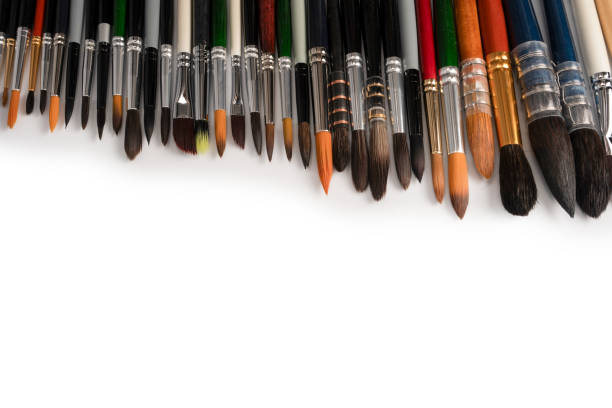 Mix of paint brushes in a row isolated on a white background.  Top view.