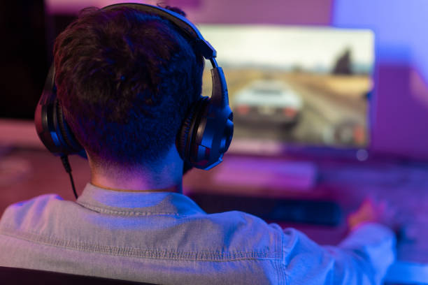 istock Man engaged in an intense gaming session 2164489357