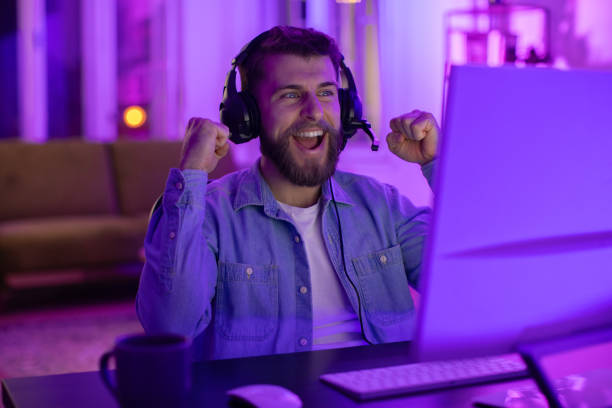 istock Happy gamer with headset enjoying a game 2164489390