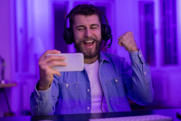 istock Gamer celebrating with a selfie at home 2164489404