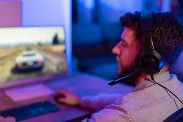 istock Focused millennial man gamer playing at home 2164489416