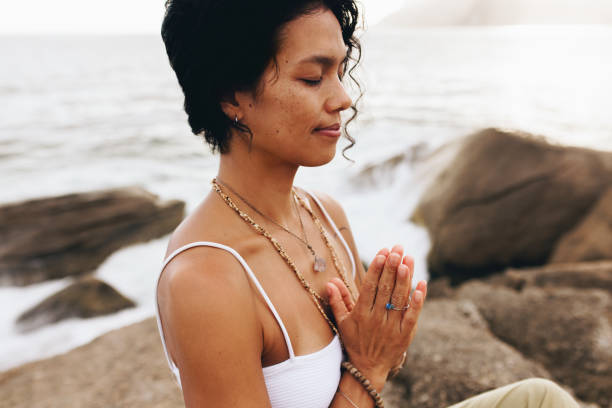istock Serene woman practicing yoga and meditation on a seaside beach 2164490080