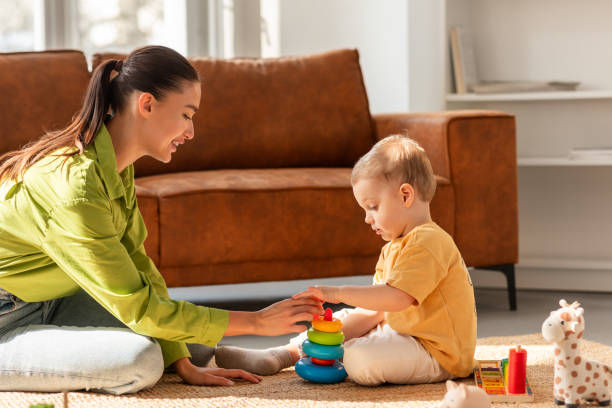 istock Woman Playing With Child on the Floor 2164491409