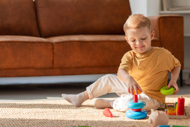 Young Boy Playing With Toys on the Floor