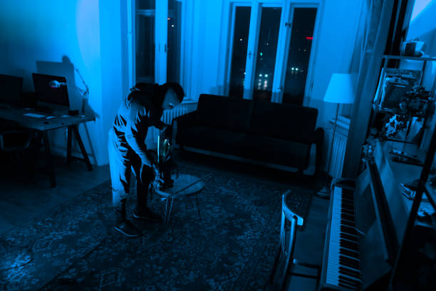 istock Lone burglar cutting into floor to commit crime 2164493452