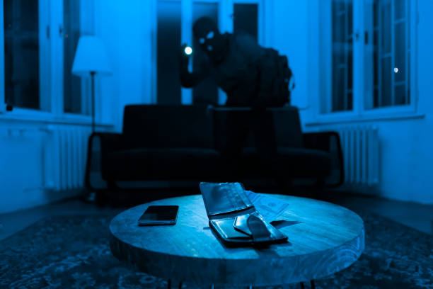 istock Thief stealing valuables from house at night 2164493461