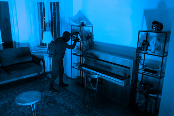 istock Burglar sneaking in a room with a piano 2164493465