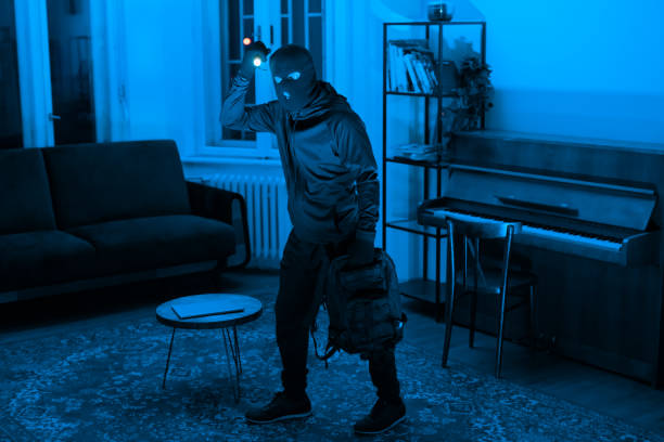 istock Person in hoodie exploring a blue-lit room 2164493485