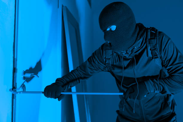 istock Masked burglar prying window open with crowbar 2164493507