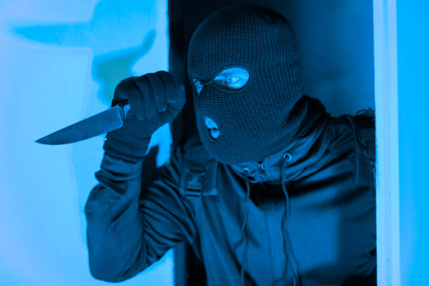 istock Burglar with knife in hand ready to attack 2164493518