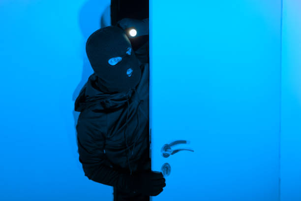 istock Thief peeking through the door at night 2164493544