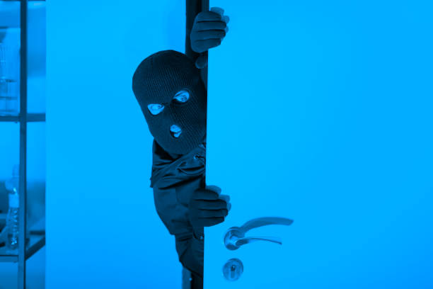 Thief cautiously entering the room at night