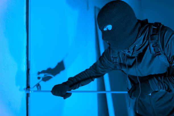 istock Thief cautiously opening clear glass apartment door 2164493557