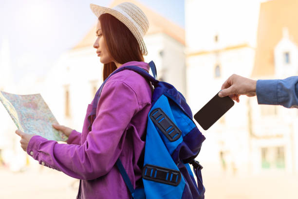 istock Tourist woman with map getting phone stolen 2164496001