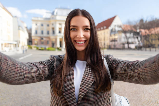 istock Happy millennial lady taking a selfie outdoors 2164496025