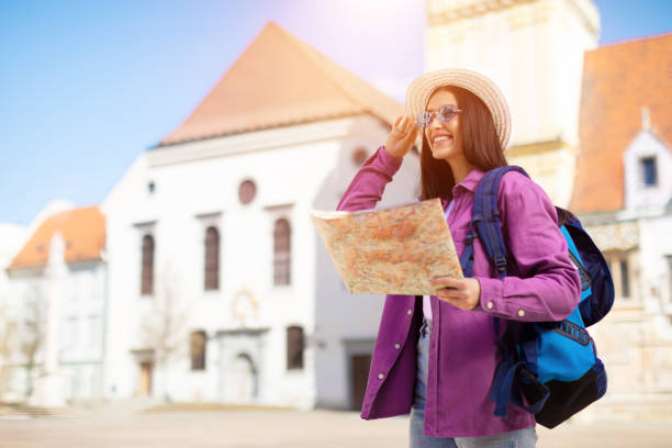 istock Lady with map wearing hat and sunglasses 2164496031