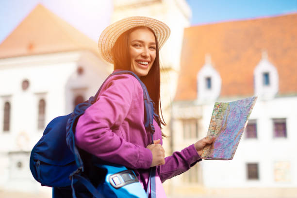 istock Joyful traveler with backpack and map in city 2164496046