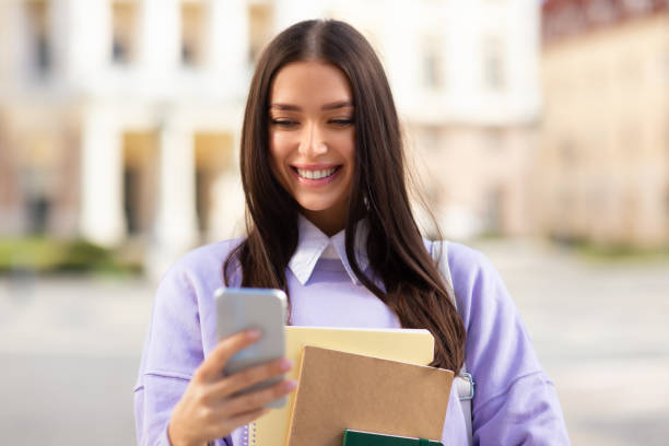 istock Millennial woman student using smartphone in the city 2164496054