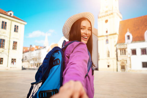 istock Adventurous millennial lady exploring city, holding cameraman hand 2164496085