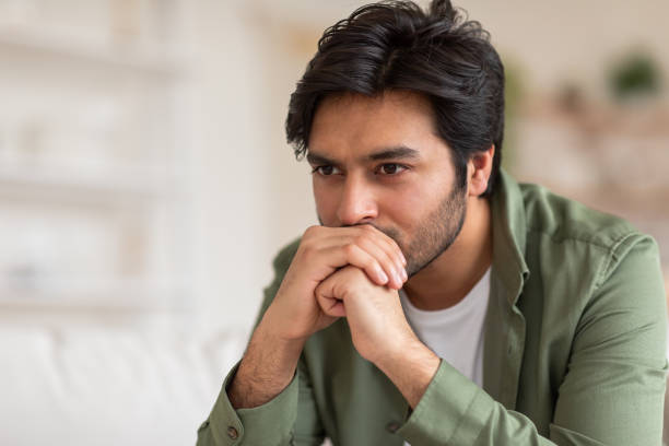 istock A Thoughtful Man Contemplating Indoors During the Day 2164497739