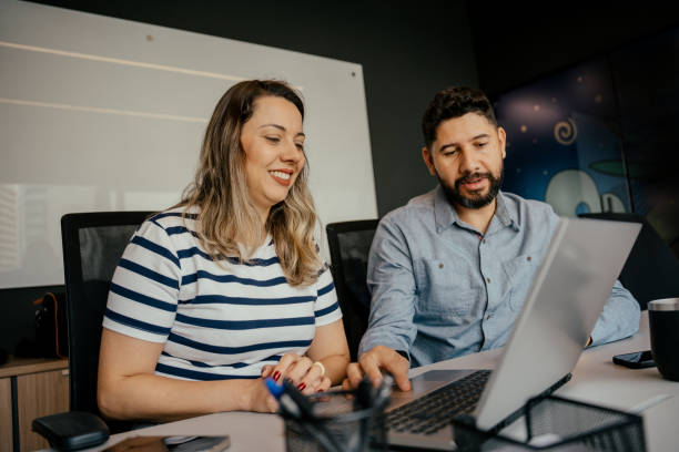 istock Two coworkers talking in the office 2164499365