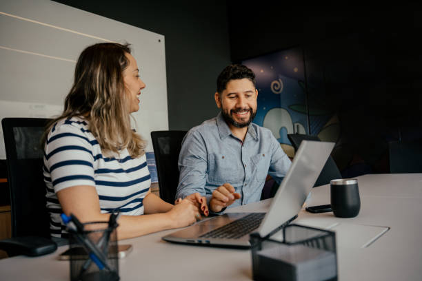 istock Two coworkers talking in the office 2164499366