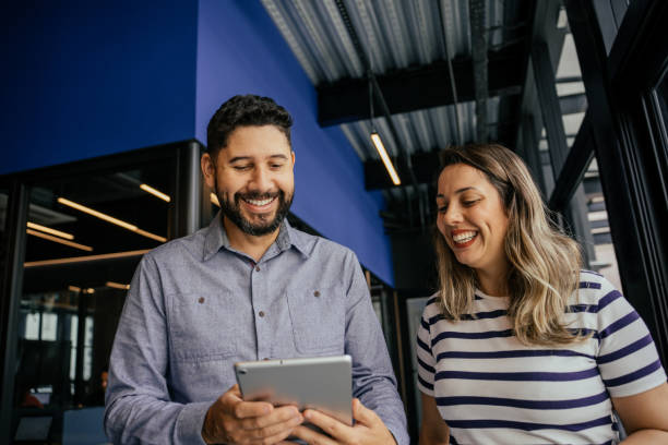 istock Two coworkers talking in the office 2164499426