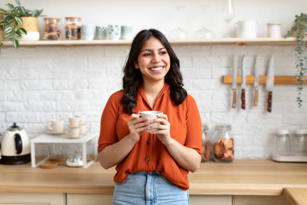 istock Cheerful middle eastern woman standing in modern kitchen 2164499507