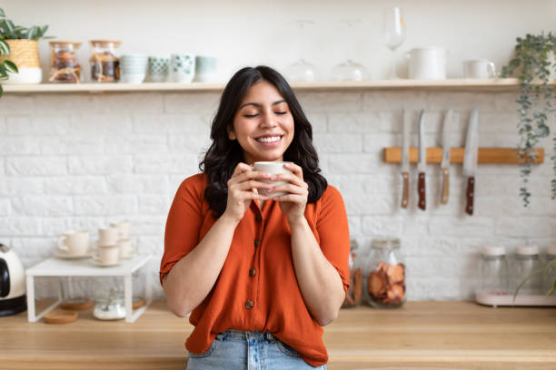 istock Woman savoring a warm drink at home 2164499510