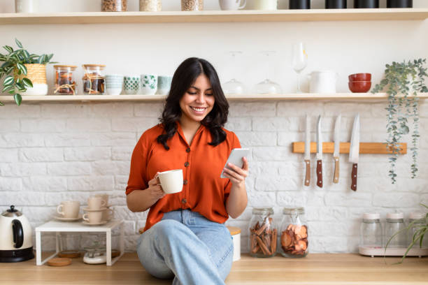 istock Relaxed woman texting on smartphone at home 2164499514