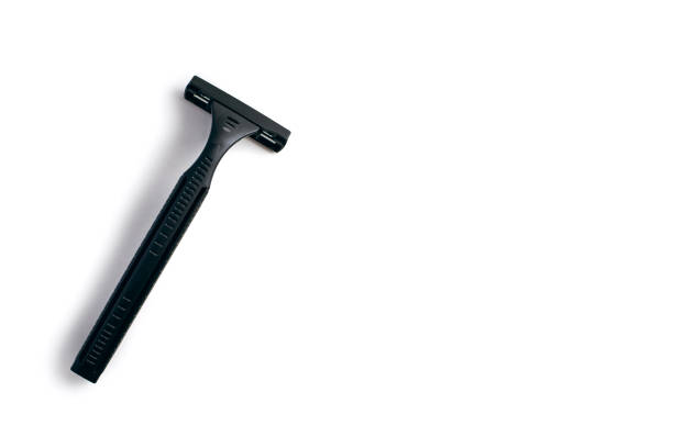 Several razor blades and handles are scattered artistically on a clean white surface. The design showcases their sleek lines and modern aesthetic, ideal for grooming activities.